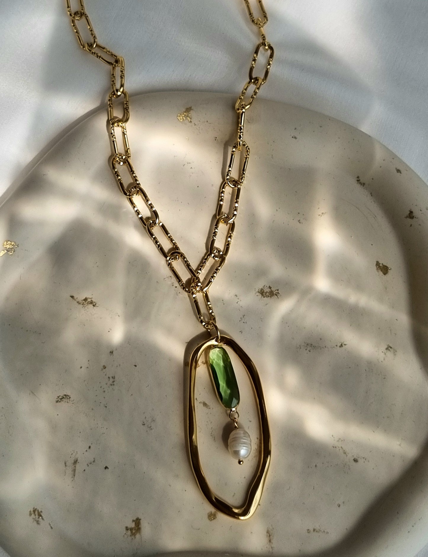 Steel chain necklace with an asymmetric pendant