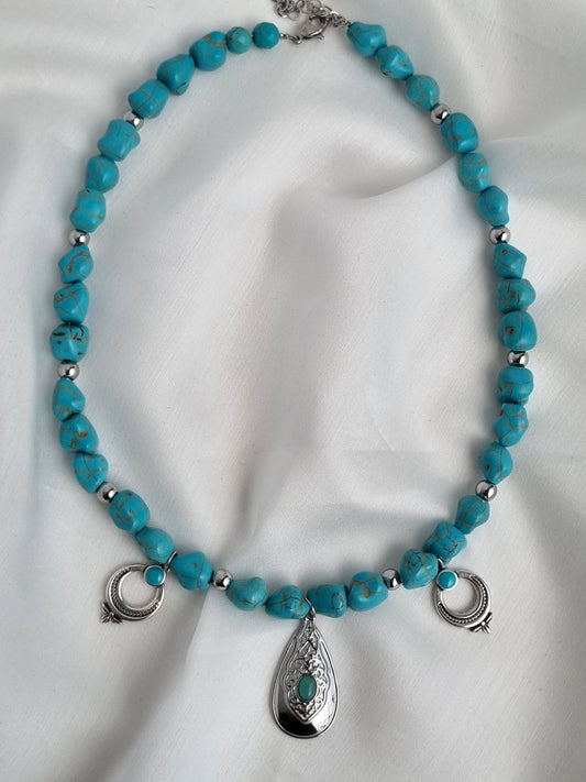 Necklace with howlite beads and a steel pendant