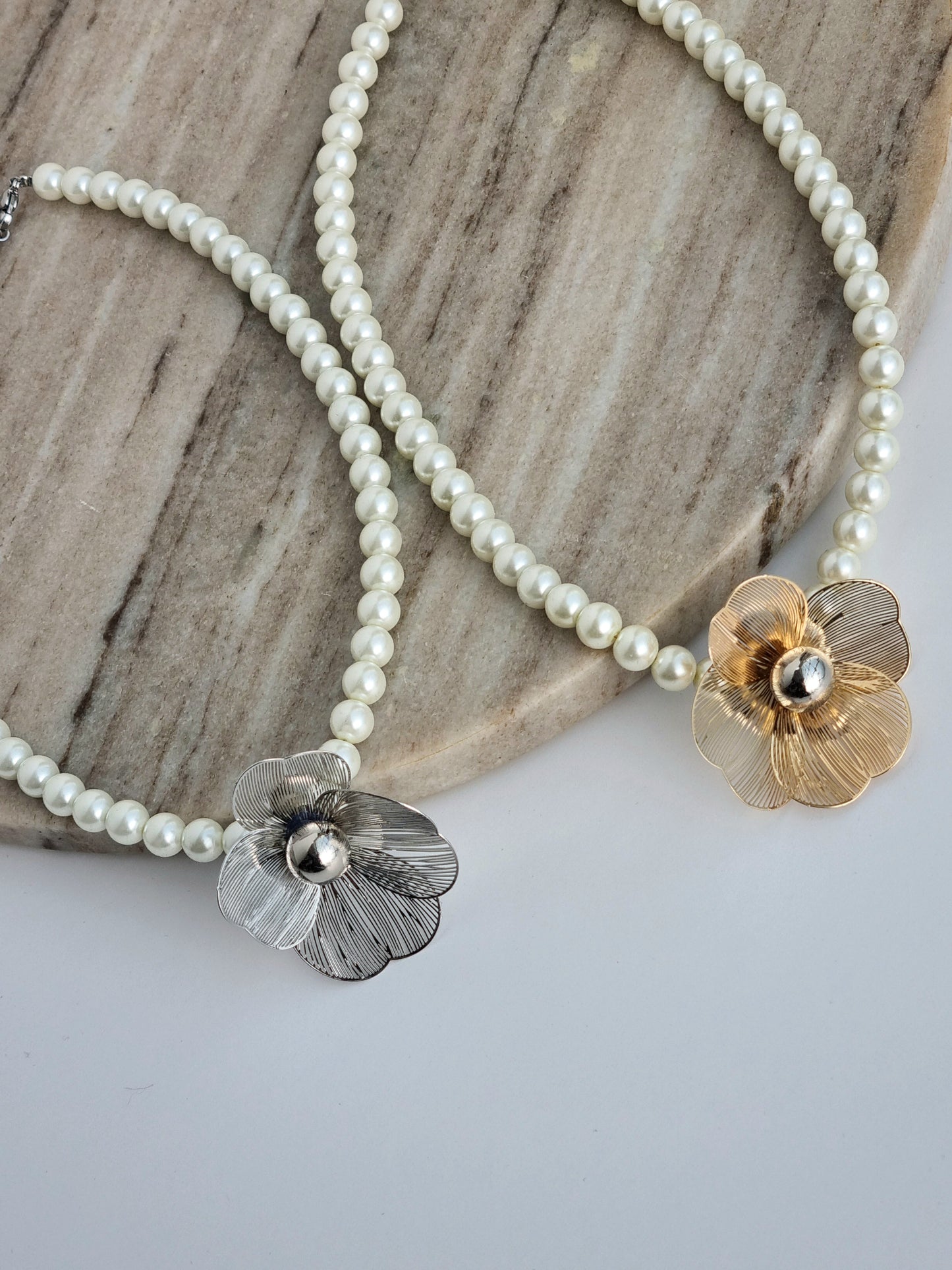 Pearl necklace with metal flower